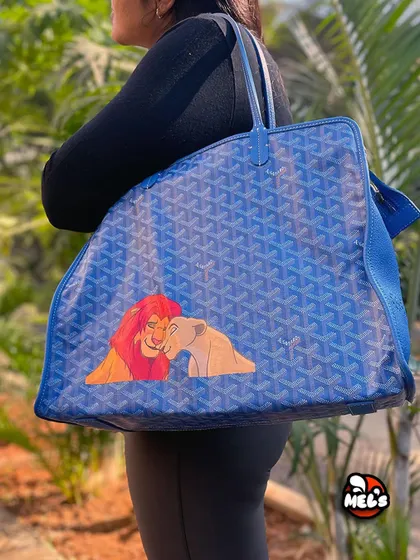 A model shot of the finished Lion King Goyard tote, showing how the custom artwork looks when the bag is carried.