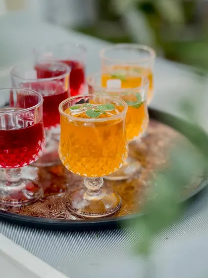 A close-up of the colorful Kokam and Iced Tea mocktails, served in elegant glassware. These traditional flavors are always a welcome treat.