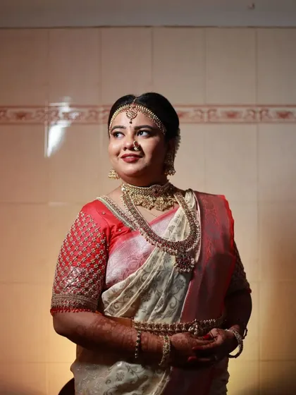 A beautiful profile of the bride, showcasing the choker, haram, and matha patti.