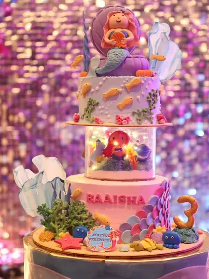 This stunning three-tier mermaid cake features a lighted stand that makes the underwater scene glow. It's a truly magical centerpiece for a special third birthday.