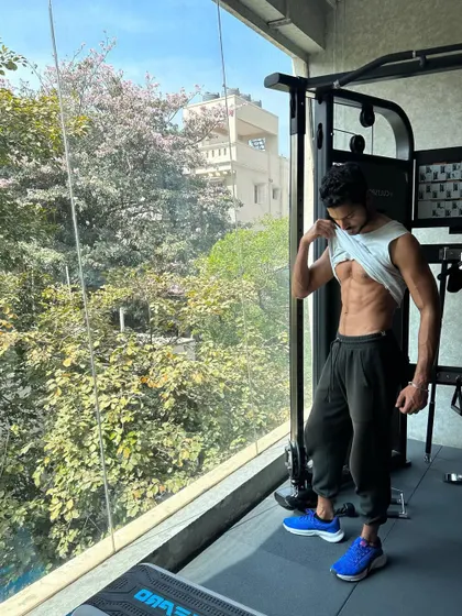 A wider shot of my gym physique, with natural light from the window creating a great contrast.