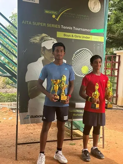 Ishaan Yadlapalli showcasing his trophies after winning the doubles and finishing as the runner-up in singles at the AITA Championship Series. This highlights his versatility and endurance across multiple matches.