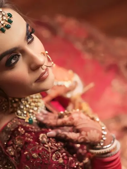 An upward glance from the bride, her eyes full of dreams. This portrait highlights her stunning makeup and the beautiful details of her maang tikka.