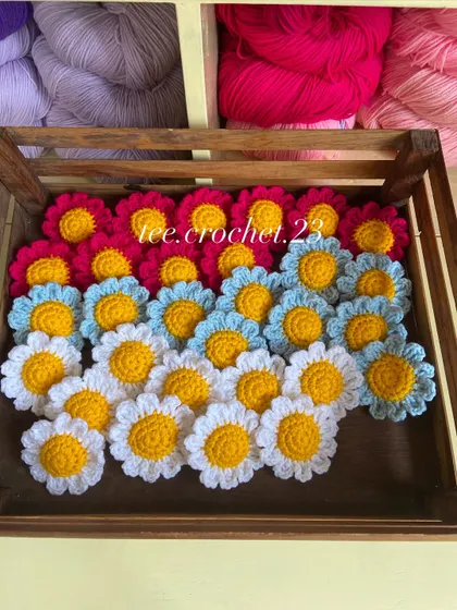A crate of colorful daisy heads, another versatile option for decor or keychains.