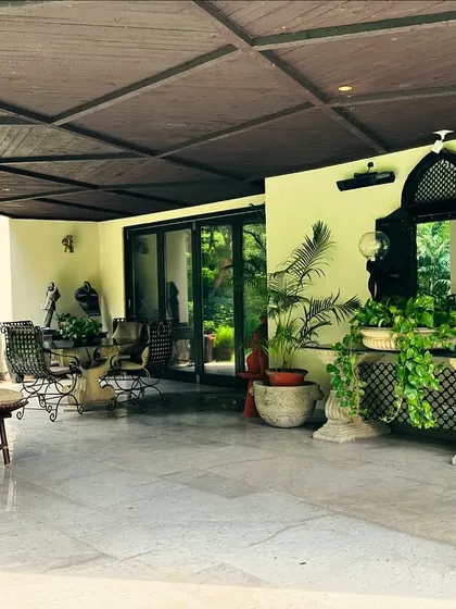 The full view of the antique-inspired covered patio, which serves as a graceful transition between the home and the garden.