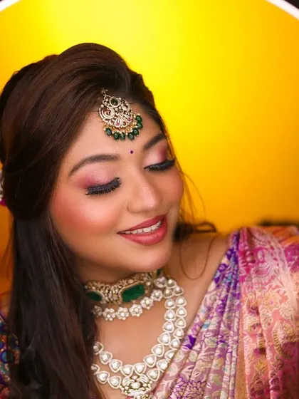A stunning close-up of the bride, framed by a ring light that highlights her intricate jewelry and flawless makeup.