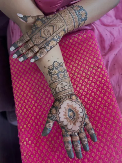 A two hand view of the central lotus design, showing its symmetry and the additional motifs on the other hand.