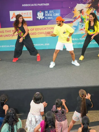 Another shot of us on stage, leading the crowd and the kids in a fun Zumba routine. The joy on their faces was priceless.