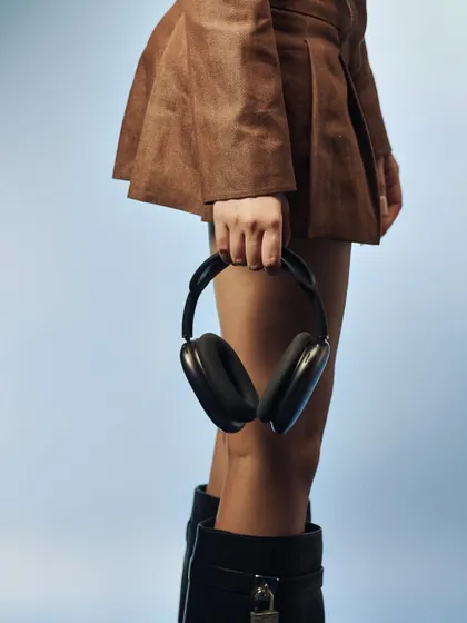 A detail shot focusing on the props. The headphones and the model's pose are key elements in building the retro-tech aesthetic of the "Connecting People" series.