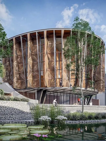 An alternate view of the main auditorium building for the Centre for Excellence. The building's form and facade are designed to be a landmark within the campus, surrounded by trees and reflective water ponds.
