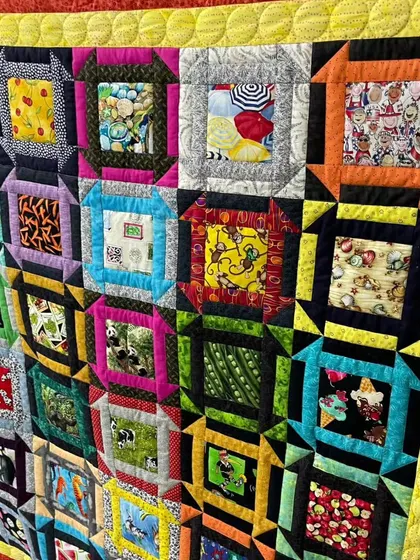 A close-up of a colorful "window frame" quilt.