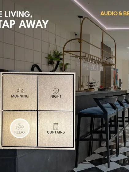 Fine living is just a tap away. This image highlights a custom-labeled smart keypad in a modern bar area, offering preset scenes for 'Morning', 'Night', and 'Relax' to instantly adjust the ambiance.