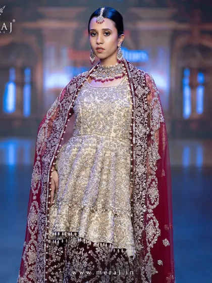 A close-up of the Gold and Maroon Indo-Western ensemble, highlighting the bold zardosi hand embellishments.