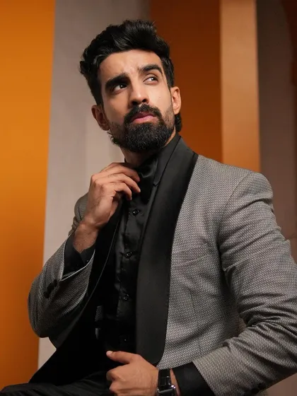 A closer view highlights the texture of the grey fabric against the smooth satin lapel. It’s a sophisticated combination that works for corporate events, cocktail parties, and formal celebrations.