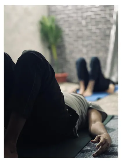 A moment of relaxation and gentle stretching during a morning flow class. These quiet moments are just as important as the challenging poses.