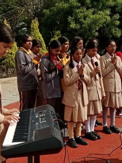 During a special assembly for World Environment Day, students perform a song about nature, accompanied by a keyboardist.