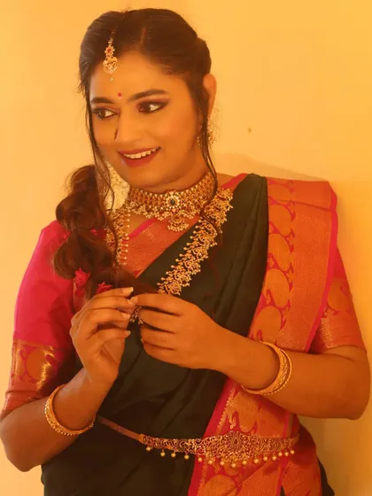 A happy, candid moment from an engagement shoot. The makeup is designed to look great both in person and on camera, with a focus on enhancing her features naturally.