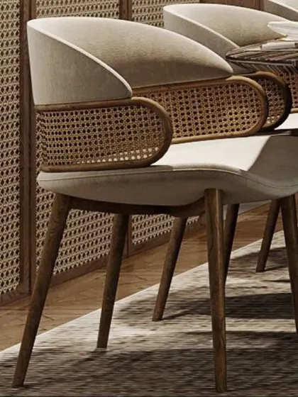 A perfect example of a dining or accent chair that blends modern and natural elements. This chair features a comfortable upholstered seat with a beautifully crafted rattan cane back and sleek wooden legs.