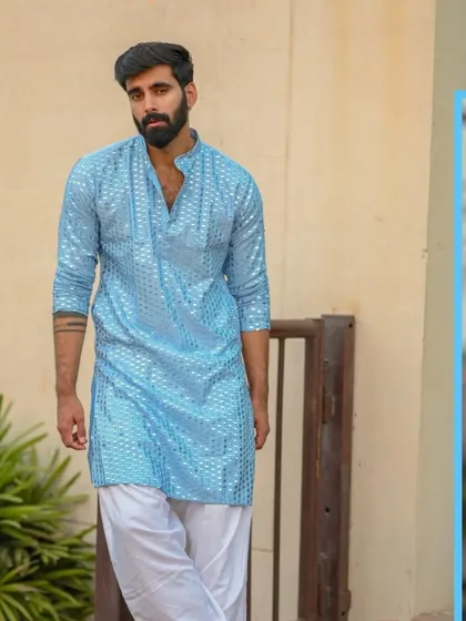A sky blue kurta with mirror work, a fresh and vibrant option for daytime celebrations.