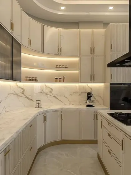 A kitchen designed for those who love to cook. We conceptualized this space with a sweeping curved counter, marble-patterned backsplash, and a neutral color theme, enhanced by integrated lighting and gold PU grooving for a truly luxurious feel.