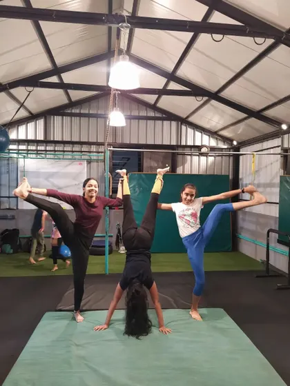 A great display of strength and flexibility from three of my students. One holds a steady handstand while the other two perform standing splits, all working together on the mat.