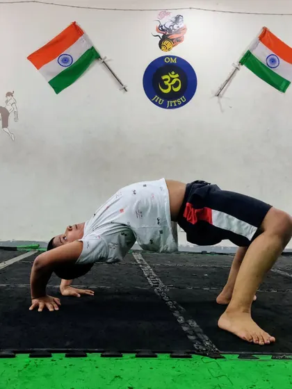 This student is also working on his backbend, showing great determination. Yoga is a personal journey of improvement.