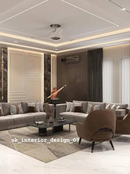 A spacious living room with a large sectional sofa and a feature wall with dark marble and wood paneling. The design is perfect for large families and for hosting gatherings.