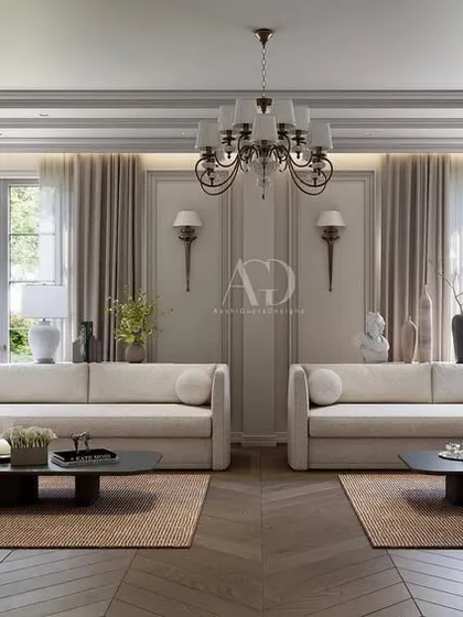 This living room design emphasizes warm tones and varied textures. The symmetrical arrangement of sofas creates a formal conversation area, while the herringbone wood floor adds a classic, durable foundation.