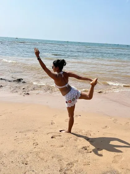 Inhaling courage and exhaling fear in Natarajasana. The dancer's pose is an expression of joy and freedom, and there's no better place to feel that than on a wide-open beach with the sea stretching out before you.