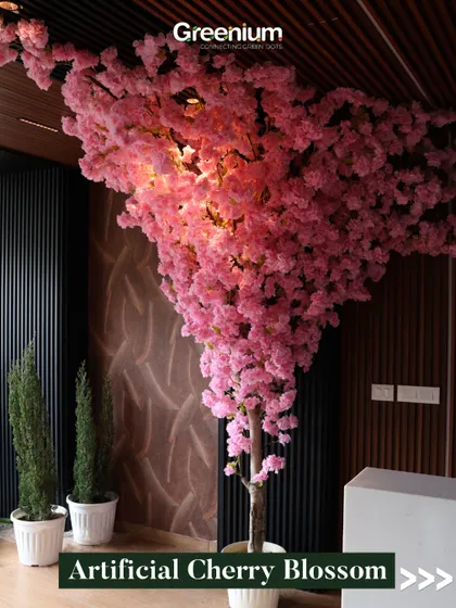A close-up of the illuminated artificial Cherry Blossom tree. The lighting from within gives the blossoms a warm glow, creating a magical and inviting ambiance.