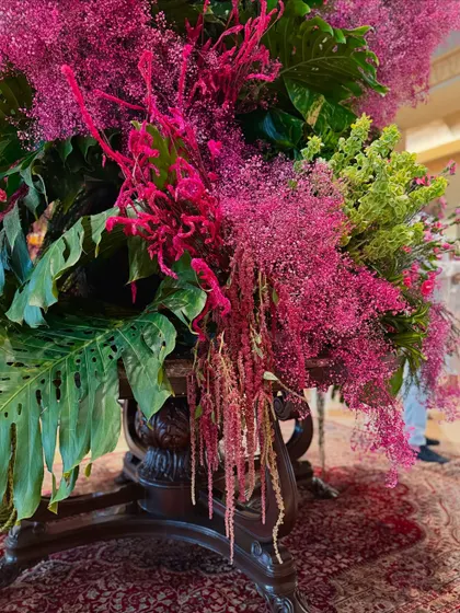 A close-up on the cascading elements of the arrangement. The interplay of different textures and shades of pink and green creates depth and visual interest.