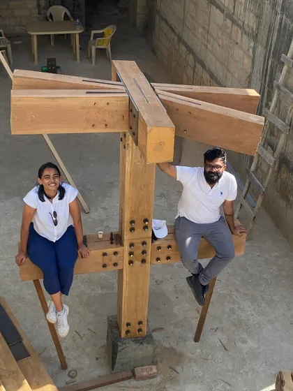 Team members perched on a completed timber column mockup at the House of Galleries. Site visits are a time for both serious work and team camaraderie.