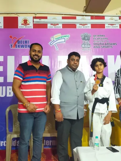 Posing with our silver medalist at the Delhi Taekwondo State Championships. We support our students on and off the mat.