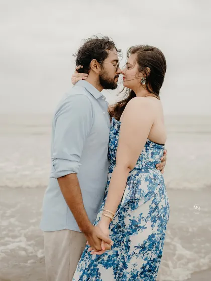 A quiet, intimate moment just before a kiss. Holding hands by the water, this shot focuses on the anticipation and deep affection between the couple.