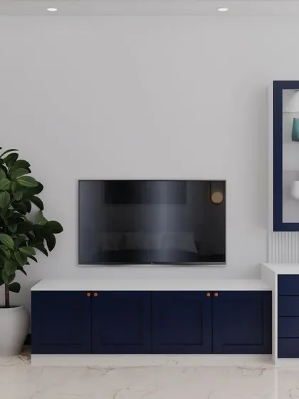 The TV unit in this bedroom continues the blue and white theme with sleek profile shutters and a fluted back panel behind the attached study unit. It's a perfect blend of style and practicality.