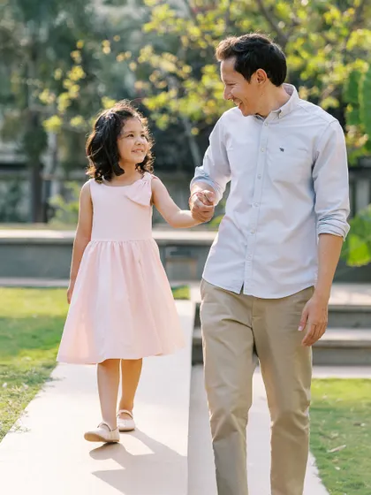 A father and daughter walking hand-in-hand. A sweet and timeless moment of connection.