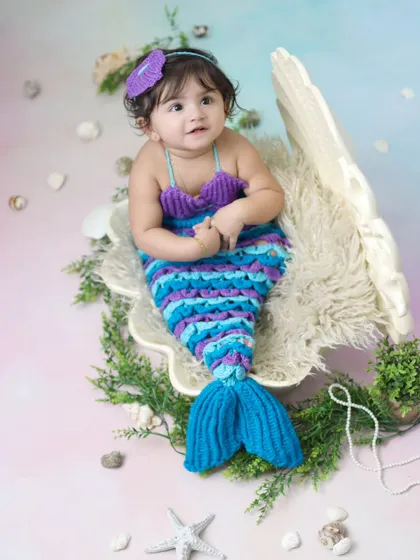 A full-length view of our adorable mermaid costume, complete with a colorful tail and seashell top. We create a dreamy, pastel-colored ocean backdrop to complete the fantasy.