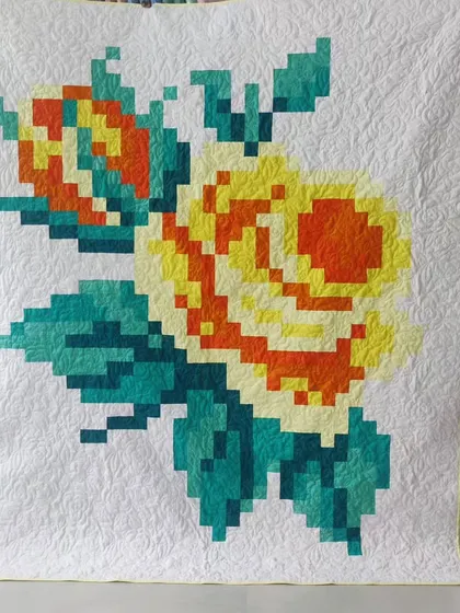 Another take on the pixelated rose, this time in warm yellows and oranges. The intricate quilting adds texture and makes the design pop.