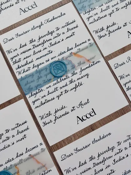A little note of appreciation goes a long way. These notecards were hand-written for a private event for Accel, featuring classic black ink on white paper with a blue vellum band and a custom wax seal.