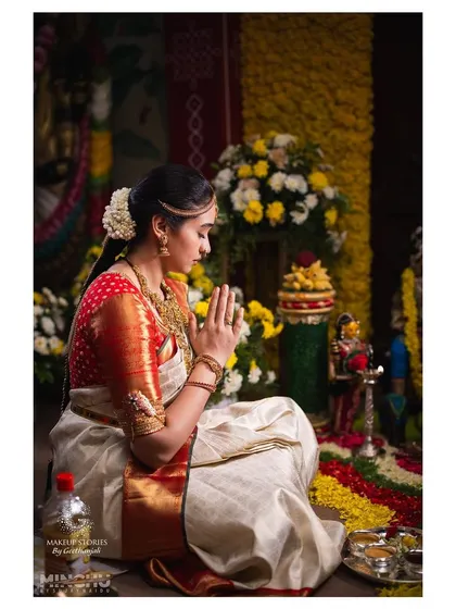 A moment of prayer during Priyanka's wedding ceremony. Her serene expression is complemented by the simple, elegant makeup that allows her natural beauty to be the focus.