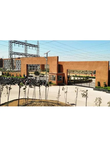 The main entrance gate of Sage University, designed to be a grand and welcoming statement. The monumental scale and earthy materials set the tone for the entire 12-acre campus.