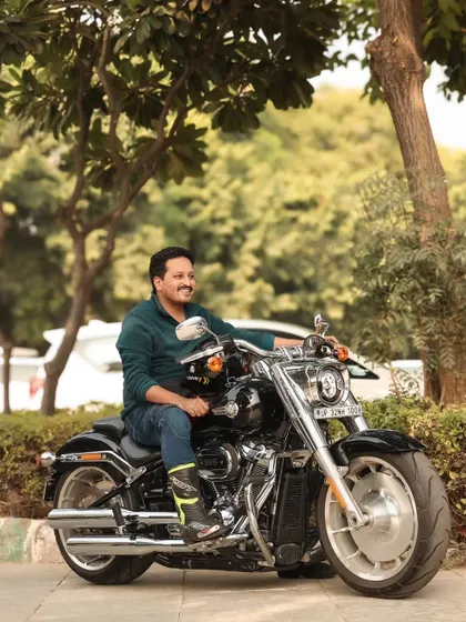 This is a duplicate of image 1, showing a close-up portrait of the rider on his Harley. It emphasizes the connection between the rider and his machine.