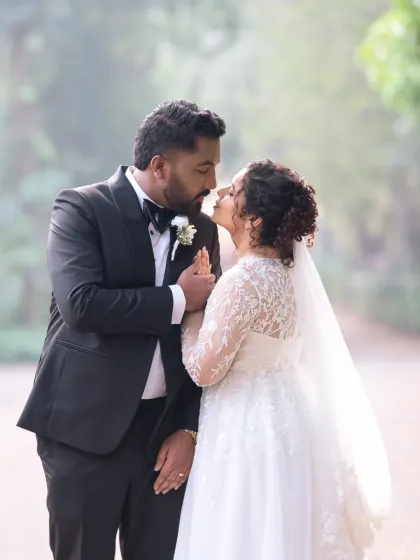 Just before a kiss. This intimate wedding portrait captures the anticipation and love between the bride and groom in a beautiful, soft-lit setting.