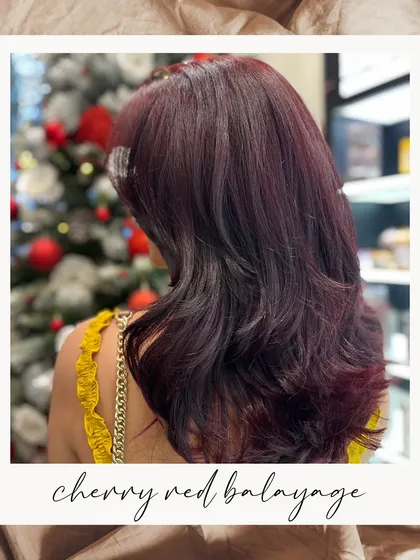 Turn heads with the ultimate festive hue. This Cherry Red Balayage is a bold and spirited choice for the holiday season.