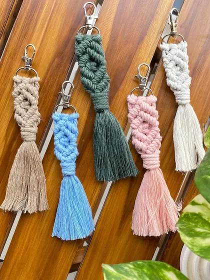 A set of our macrame keychains featuring a diamond knot pattern. These come in various colors with a tassel finish, offering a more bohemian and intricate style for gifting.