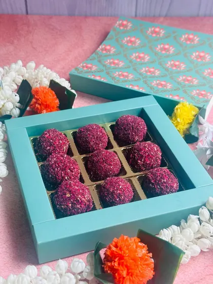 My Rose and Pistachio Truffles are presented here in their elegant gift box, surrounded by festive flowers, making them a beautiful and delicious Diwali gift.