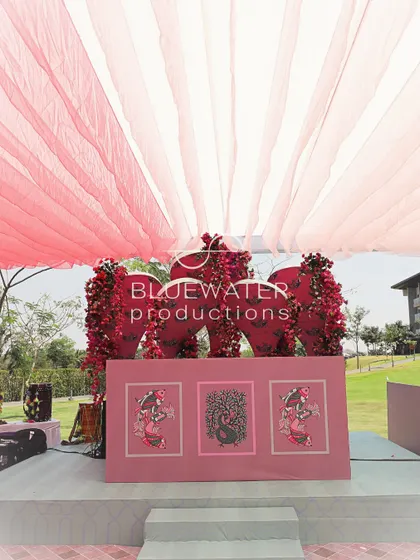 A DJ console is decorated with panels featuring Gond art, seamlessly integrating it into the event's theme.