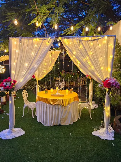 A romantic dinner for two under a canopy of fairy lights. This intimate cabana setup is perfect for a special anniversary or birthday surprise.