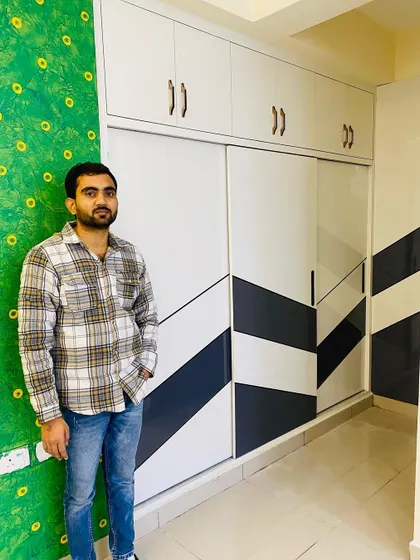 Here I am with a completed sliding wardrobe. The black and white geometric pattern on the doors gives it a very modern and graphic look.