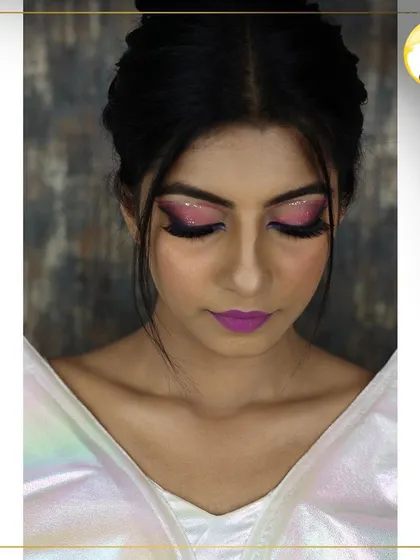 A detailed shot of the glittery pink and purple eye makeup from the cocktail party look. Learning to work with loose glitter is a fun and valuable skill for any aspiring makeup artist.